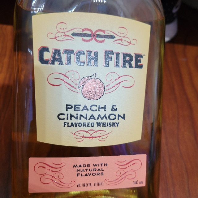 Catch fire peach & cinnamon flavored whiskey